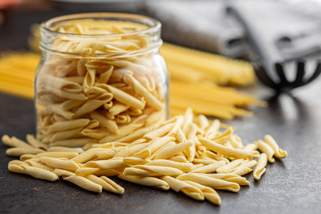 Fusilli Pugliese. Italian twisted pasta and spaghetti on the black table.の写真素材