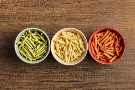 Fusilli Pugliese. Italian tricolor twisted pasta in the bowl. Top view.の写真素材