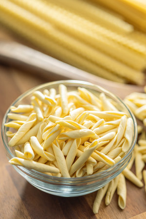 Fusilli Pugliese. Italian twisted pasta in a bowl on the wooden table.の写真素材
