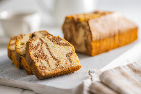 Marble sponge cake. Cake with cocoa and vanilla taste on the cutting board.の写真素材