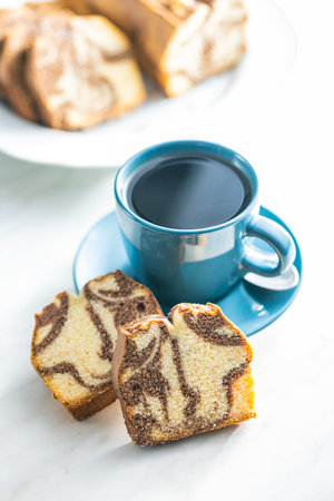 Marble sponge cake and coffee cup. The cake with cocoa and vanilla taste.の写真素材
