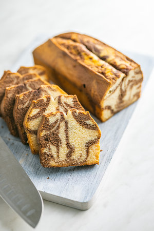 Marble sponge cake. Cake with cocoa and vanilla taste on the cutting board.の写真素材