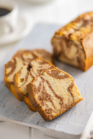 Marble sponge cake. Cake with cocoa and vanilla taste on the cutting board.の写真素材