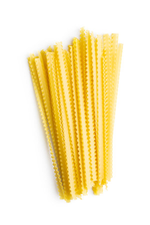 Uncooked mafaldine paste. Raw long mafalda pasta isolated on the white background.の写真素材