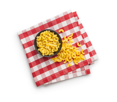 Raw macaroni pasta in a bowl. Uncooked rigatoni isolated on the white background.の写真素材