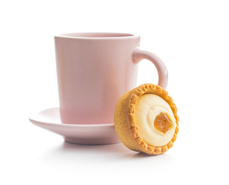 Sweet tartlets. Tasty mini tarts and coffee cup. Mini pie with cream isolated on the white background.の写真素材