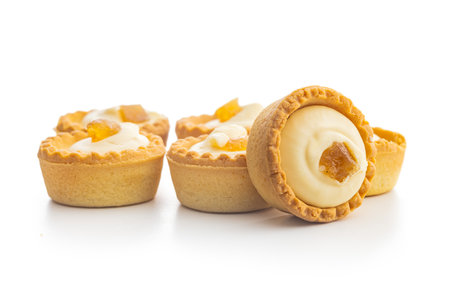 Sweet tartlets. Tasty mini tarts. Mini pie with cream isolated on the white background.の写真素材