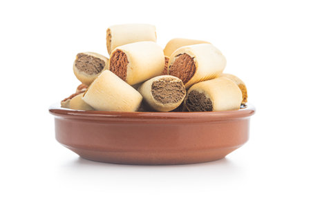 Dry animal food. Dog or cat kibble in bowl isolated on the white background.の写真素材