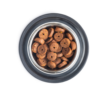Dry animal food. Dog or cat kibble in bowl isolated on the white background.の写真素材