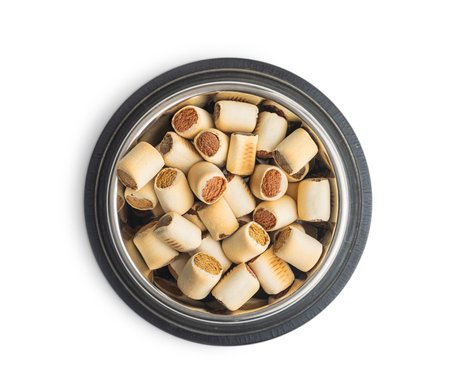 Dry animal food. Dog or cat kibble in bowl isolated on the white background.の写真素材