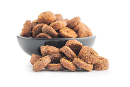 Dry animal food. Dog or cat kibble in bowl isolated on the white background.の写真素材