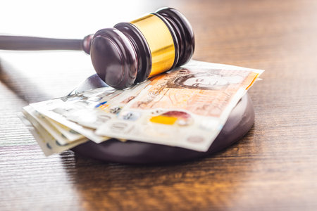 Judge gavel and British pound sterling on the wooden table.の写真素材