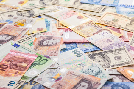 The banknotes background. Various currencies. Paper money. Euro, Czech crown, Polish zÅoty, Hungarian forint, British pound and US dollar.の写真素材