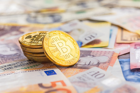 Bitcoin on the various banknotes background.の写真素材