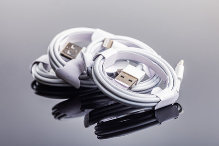 White usb charging cables on the mirror table.の写真素材