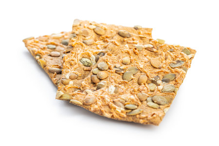 Knackebrot with pumpkin seeds. Wholegrain crispbread isolated on the white background.の写真素材