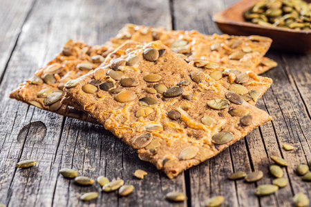 Knackebrot with pumpkin seeds. Wholegrain crispbread on the wooden table.の写真素材
