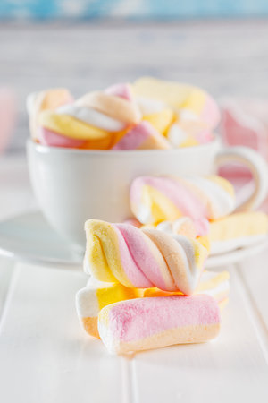 Sweet colorful marshmallows on the white kitchen table.の写真素材