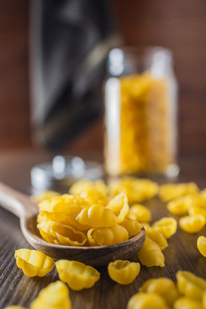 Uncooked gnocchi pasta. Raw italian pasta on the wooden table.の写真素材