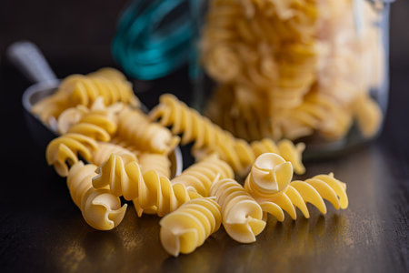 Uncooked fusilli pasta. Uncooked Italian pasta in the scoop.