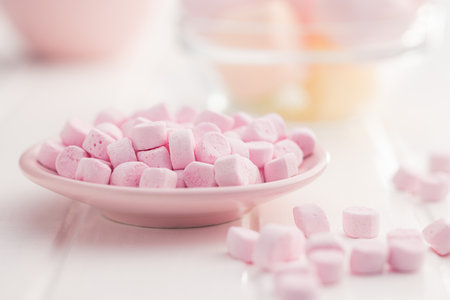 Mini sweet marshmallows candy on the plate.の写真素材