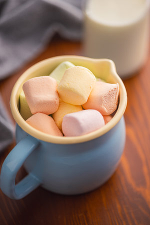 Sweet marshmallows candy in cup on the kitchen table.の写真素材