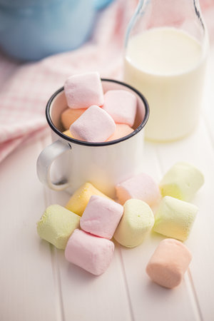 Sweet marshmallows candy in cup on the kitchen table.の写真素材