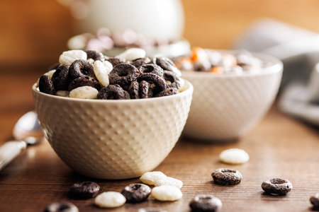 Sweet breakfast cereals in a bowl on the kitchen table.の写真素材