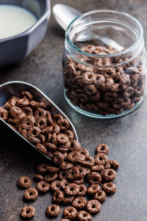 Sweet breakfast cereals in scoop on the kitchen table.の写真素材