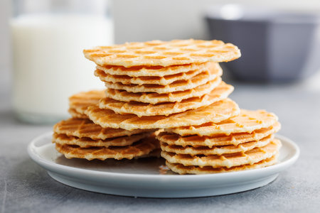 Round waffle biscuits on a plate on the kitchen table.の写真素材