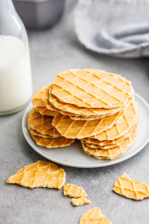 Round waffle biscuits on a plate on the kitchen table.の写真素材