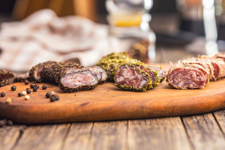 Smoked dried sausage. Sliced sausage on the cutting board.の写真素材