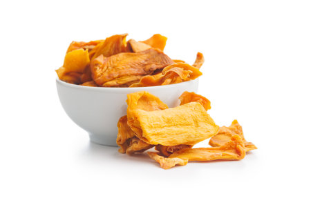 Dried mango fruit in bowl isolated on the white background.の写真素材