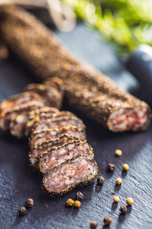 Smoked dried sausage. Sliced sausage on the cutting board.の写真素材