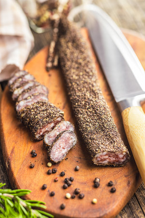 Smoked dried sausage. Sliced sausage on the cutting board.の写真素材