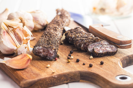 Smoked dried sausage. Sliced sausage on the cutting board.の写真素材