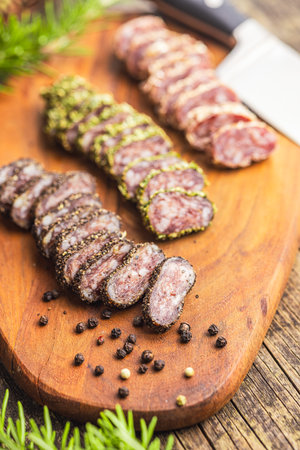 Smoked dried sausage. Sliced sausage on the cutting board.の写真素材
