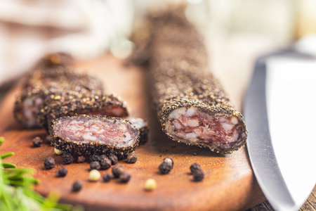 Smoked dried sausage. Sliced sausage on the cutting board.の写真素材