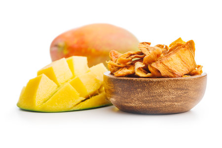 Dried mango fruit in bowl isolated on the white background.の写真素材