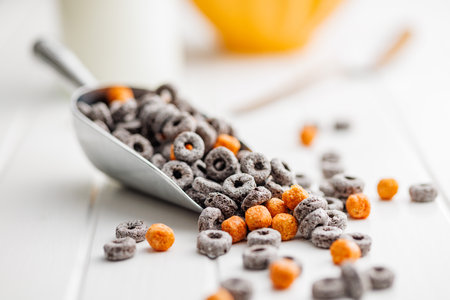 Sweet breakfast cereals in a scoop on the white table.の写真素材