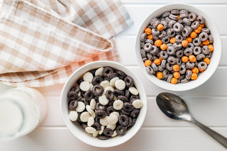 Sweet breakfast cereals in a bowl on the white table. Top view.の写真素材