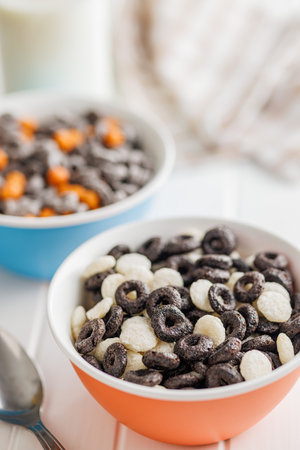 Sweet breakfast cereals in a bowl on the white table.の写真素材