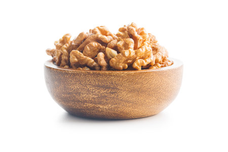 Peeled dried walnut kernels in bowl isolated on the white background.の写真素材
