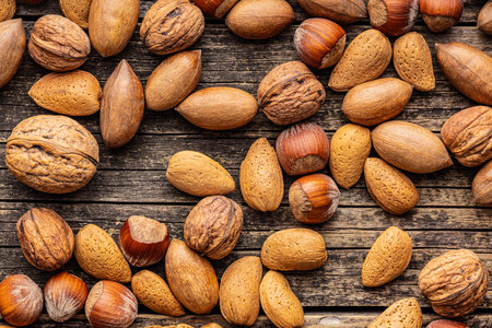 A mix of different nuts on the wooden table. Top view.の写真素材