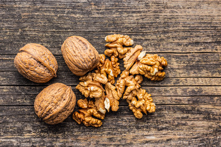 Peeled dried walnut kernels on the wooden table. Top view.