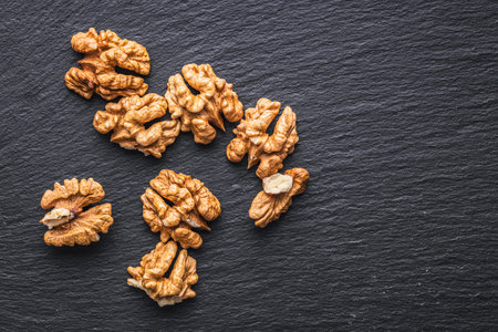 Peeled dried walnut kernels on the black table. Top view.の写真素材
