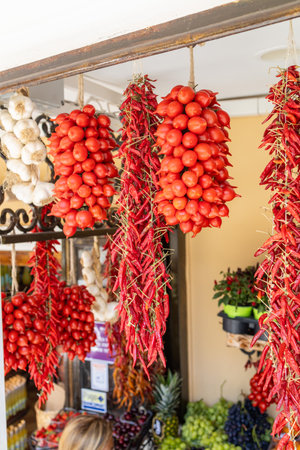 Dried Calabrian chili peppers hanging on the street marketの写真素材