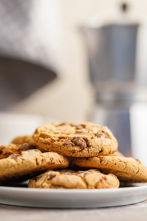 Sweet chocolate cookies on a plate on the kitchen table.の写真素材