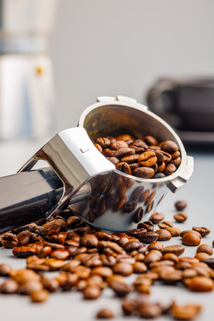 Coffee beans and portafilter on the gray background.の写真素材