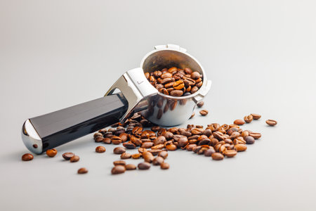 Coffee beans and portafilter on the gray background.の写真素材
